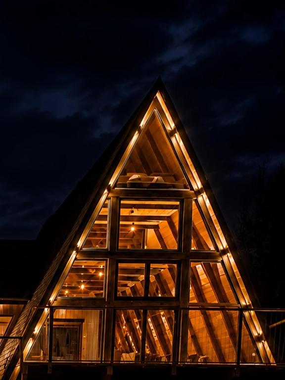 a house with lights on the roof at night at MonteRosso in Mărişel