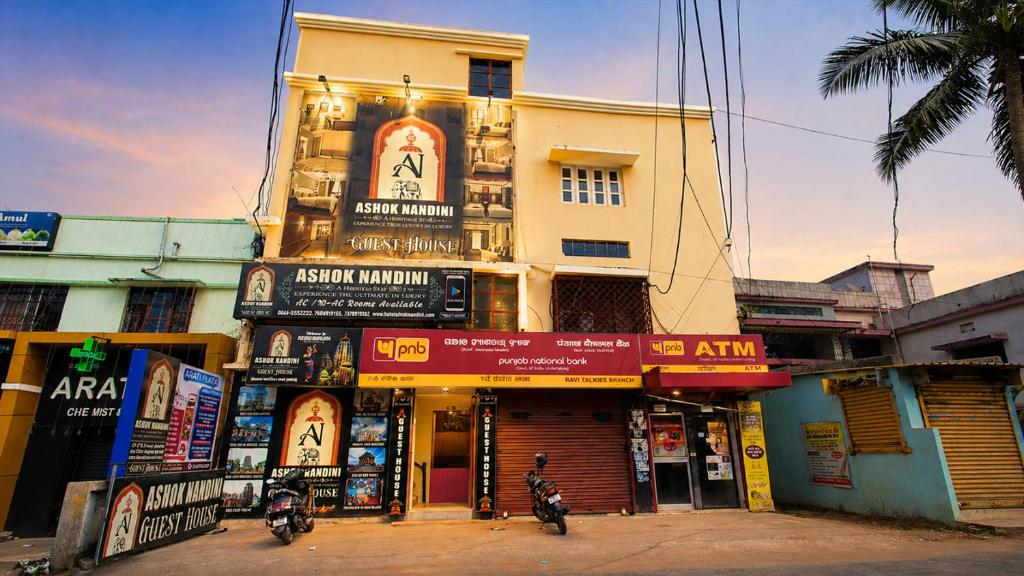 a building with signs on the side of a street at Ashok Nandini Guest House in Bhubaneshwar