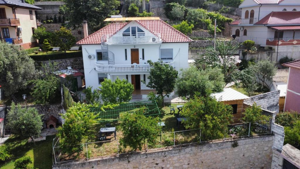 a white house with a red roof at Meti Guest House in Krujë