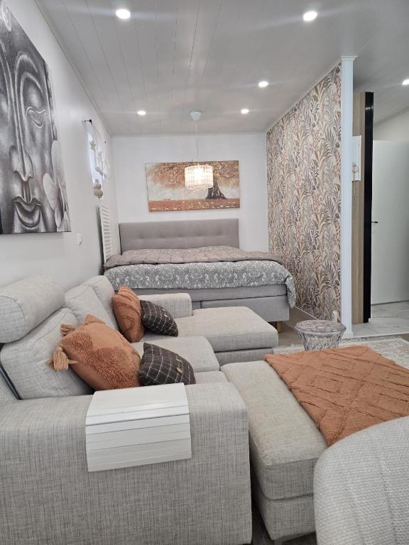 a living room with two couches and a couch at LinnankadunHelmi in Savonlinna