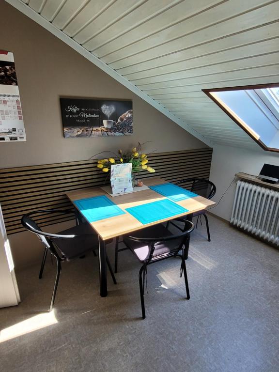 a dining room with a table and two chairs at Alexas Ferienwohnung in Windischeschenbach