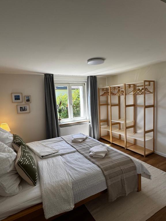 a bedroom with a bed and a window and shelves at Appartement Frieda in Seeboden