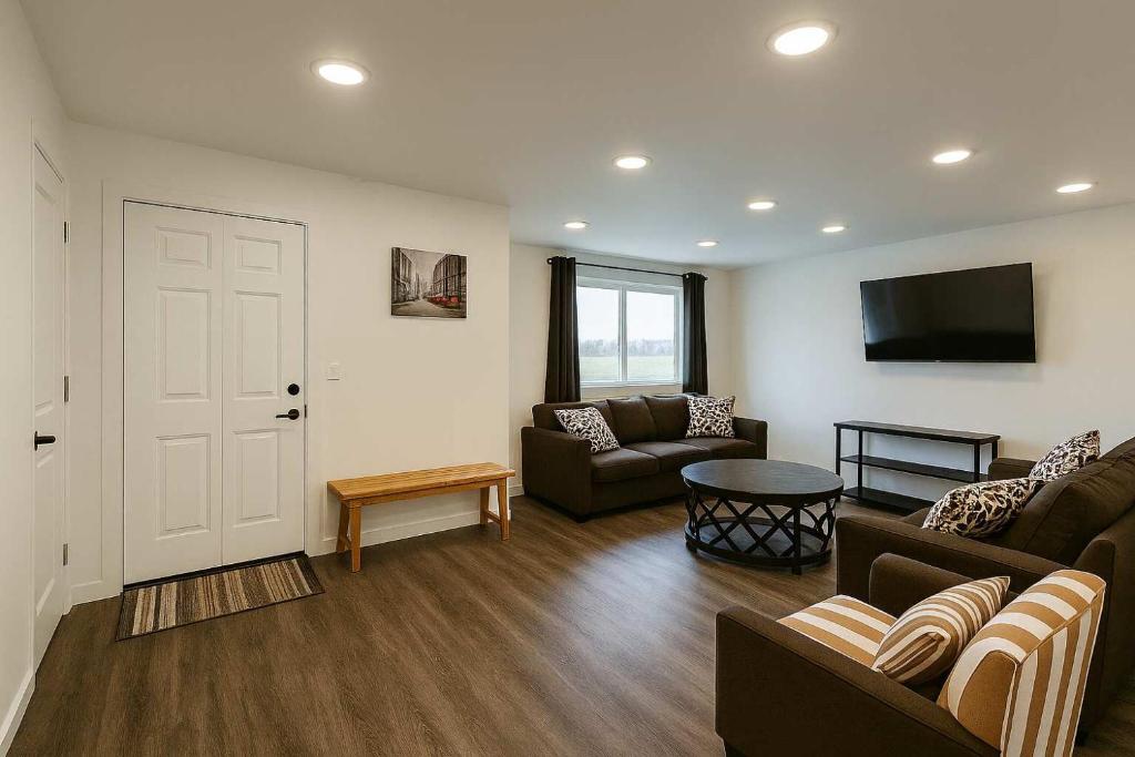 a living room with a couch and a tv at Mountain Views - Peaceful Retreat - 1BR suite in Sooke