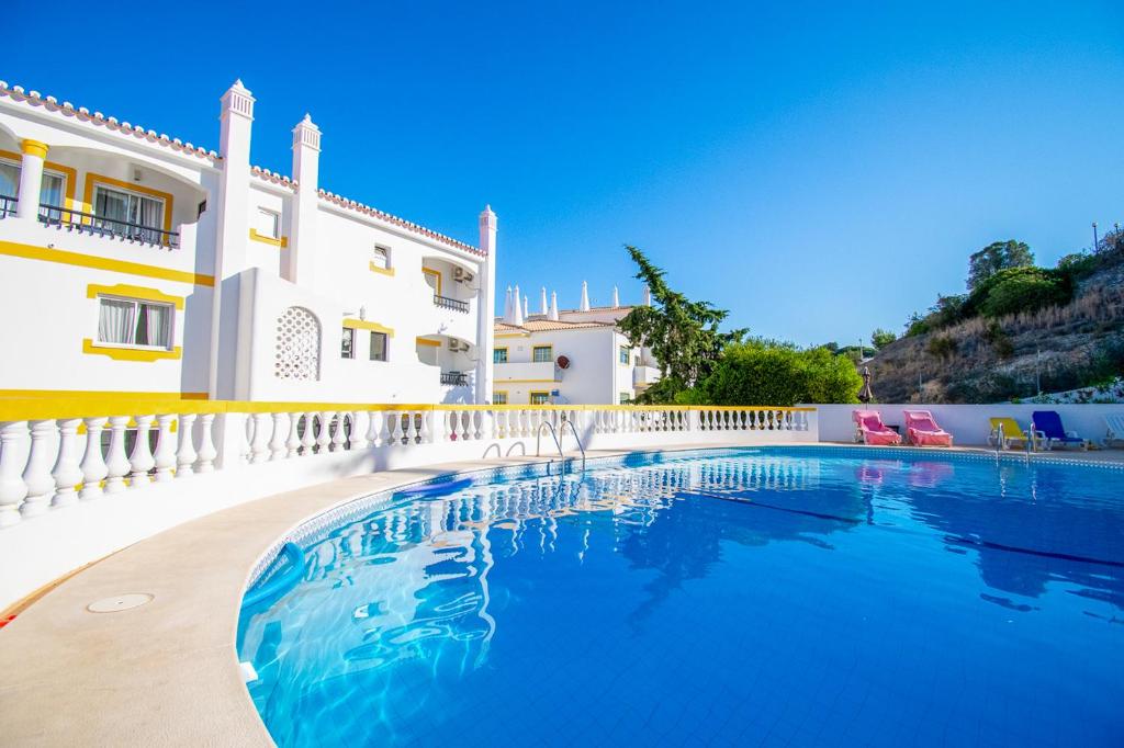 a swimming pool in front of a house at Casa Sem Pressa - Beach, Pool & Central Carvoeiro in Carvoeiro