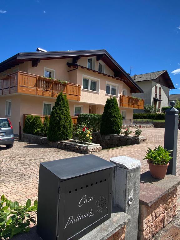 a large house with a sign in front of it at Casa Pallanch in Fai della Paganella