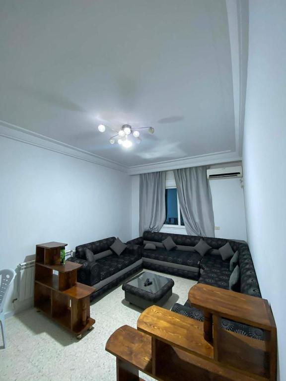 a living room with a couch and a table at Cozy Appartement Mahdia in Mahdia