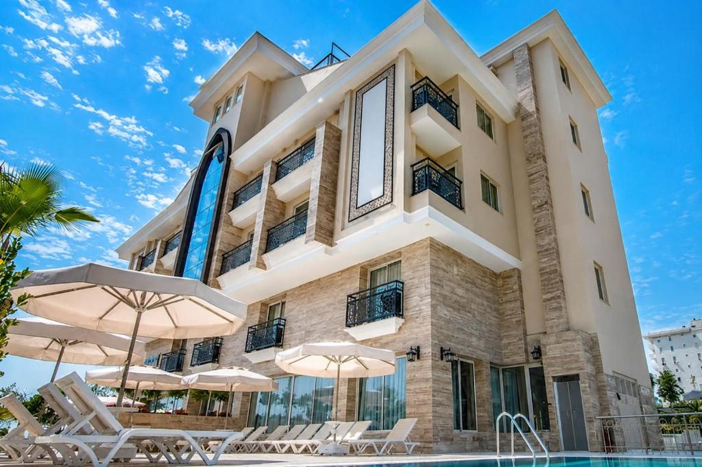 aominium building with a pool and umbrellas at Trend Park Hotel in Antalya