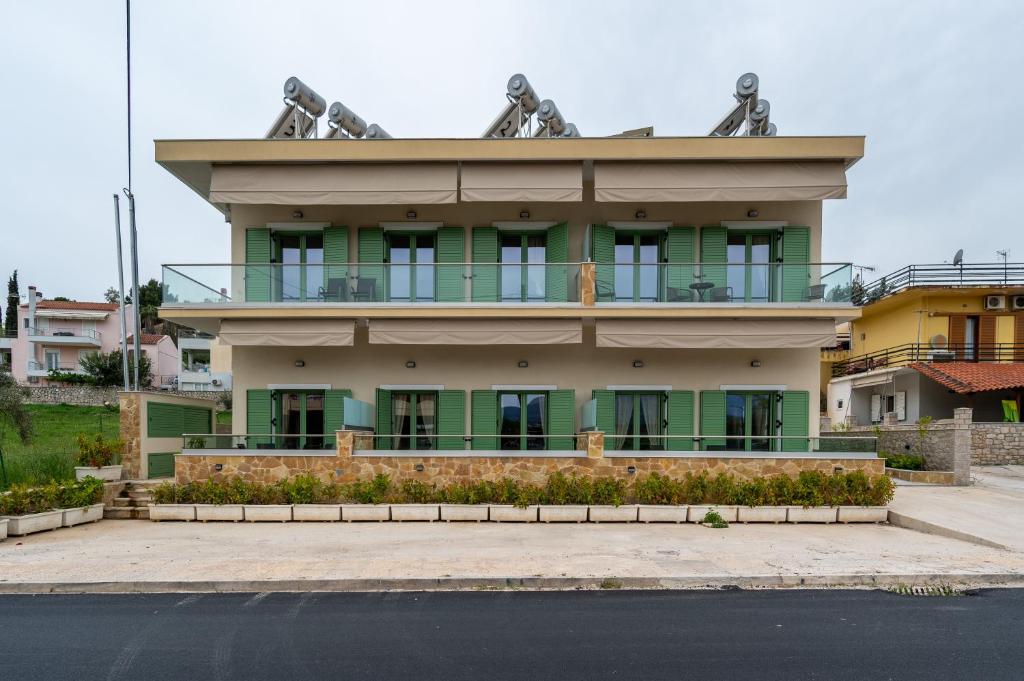 a large building with a balcony on top of it at Asini deluxe suite 2, with rooftop terrace and breathtaking views in Asíni