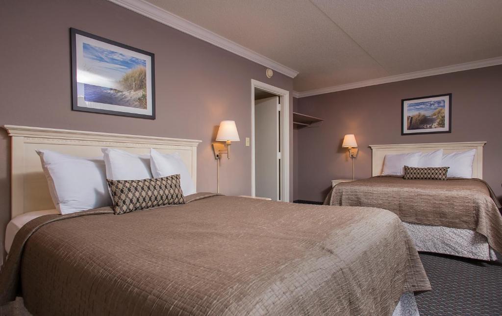 a hotel room with two beds and two lamps at Grande Shores in Myrtle Beach
