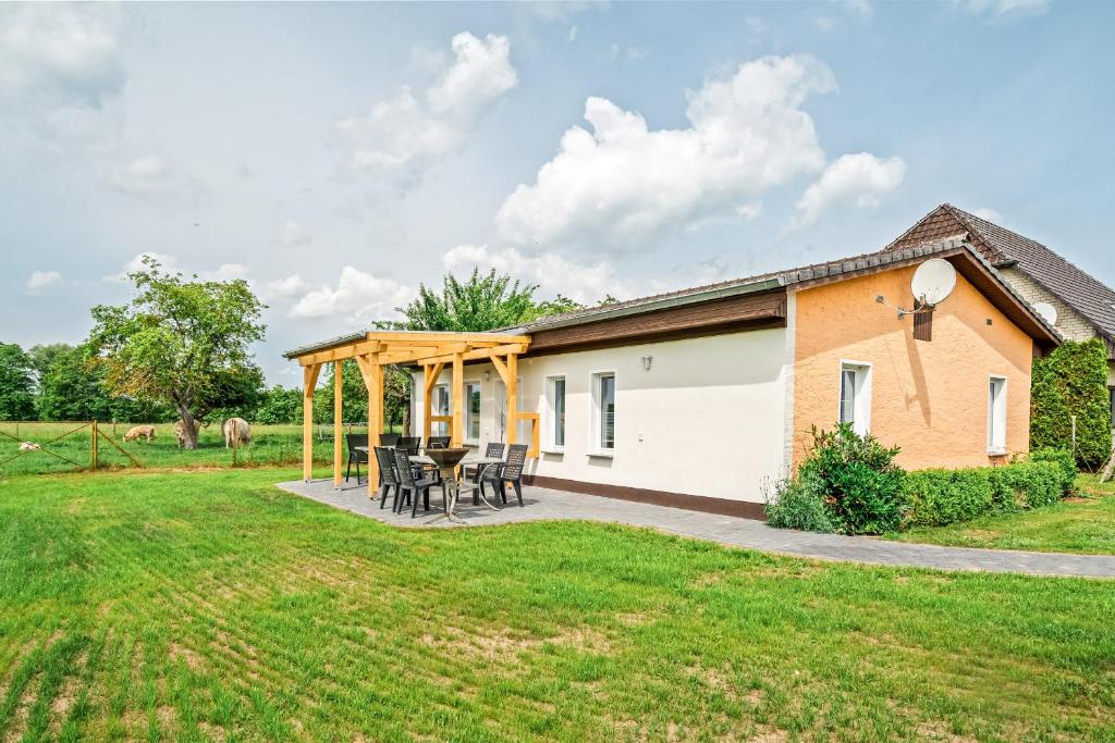 a detached house with a patio and grass yard at Ferienhaus Alt-Gaarz in Lärz