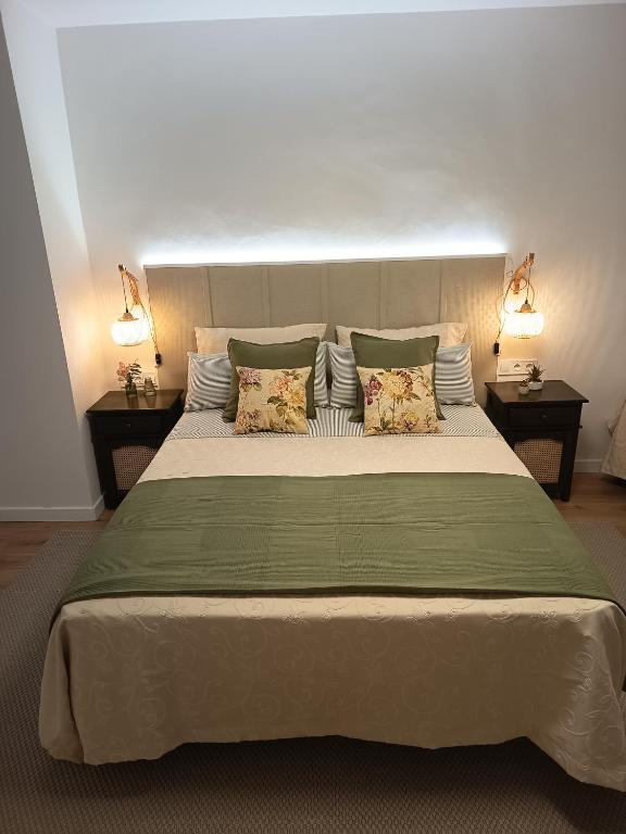 a bedroom with a large bed with two night stands at Casa Ameghino in Laujar de Andarax