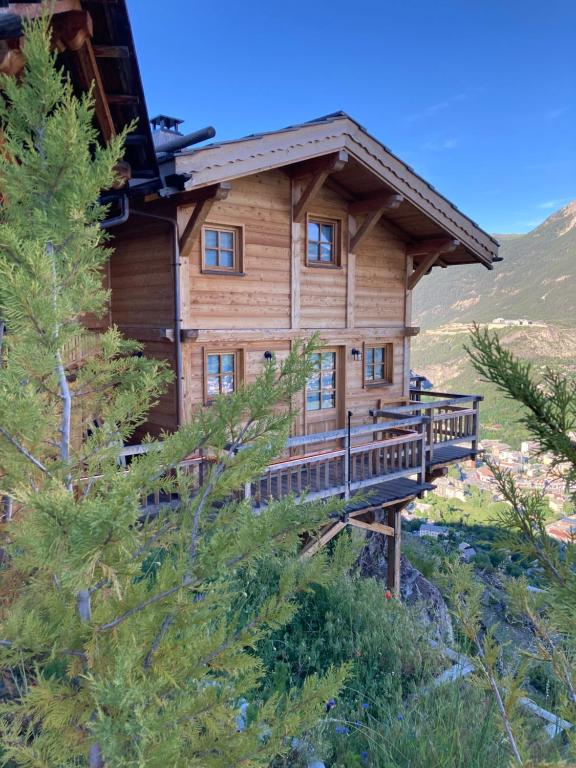 a log cabin with a bridge in front of it at Vertigo in Puy-Saint-Pierre