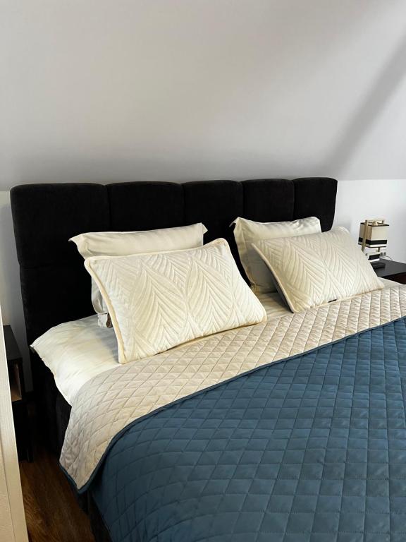 a bed with two pillows on top of it at Готель Сузірʼя in Kolomiya
