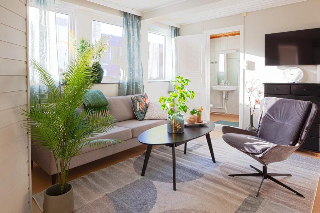 a living room with a couch and a table and a chair at Yess-Vadsø in Vadsø