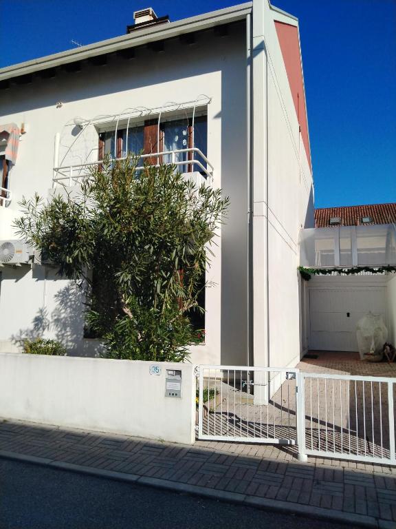 a white house with a tree in front of it at Alle Nuove Stelle in Udine
