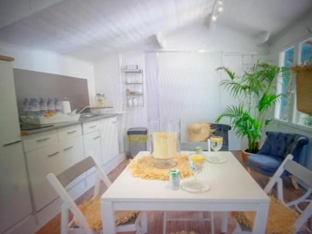 a kitchen with a white table with a cake on it at Chic Villa Webb Cannes in Cannes