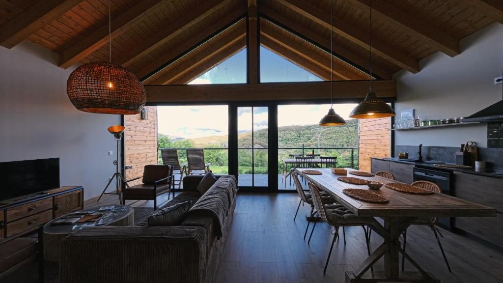 a living room with a couch and a table at La Finca del Valle in Valle de Vegacervera