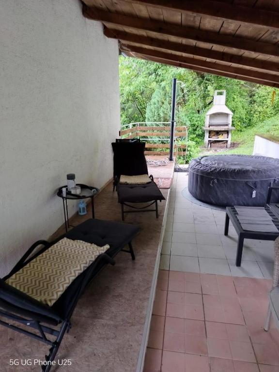 a room with a bed and chairs and a fireplace at Holiday Home Nature Plesivica in Jastrebarsko