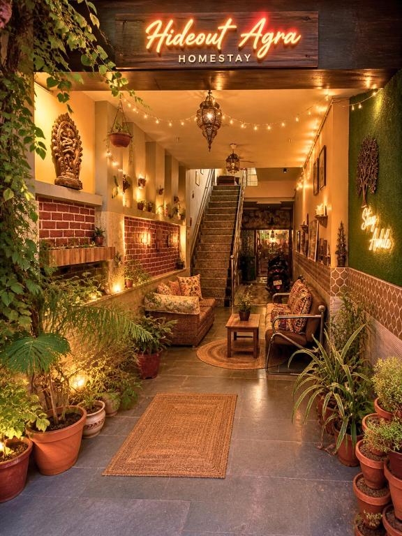 a lobby of a house with plants and lights at The Hideout Agra Garden Homestay - Near Taj Mahal in Agra