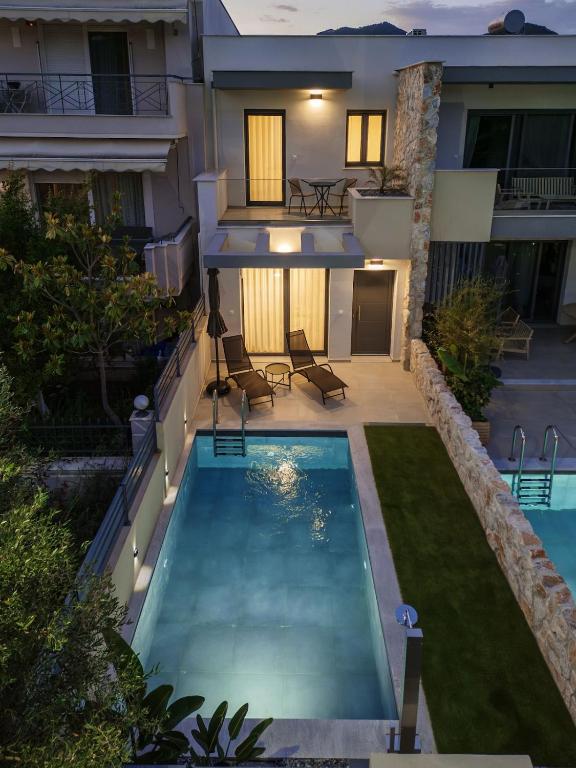 a swimming pool in the backyard of a house at No7 Pool House in Iraklitsa