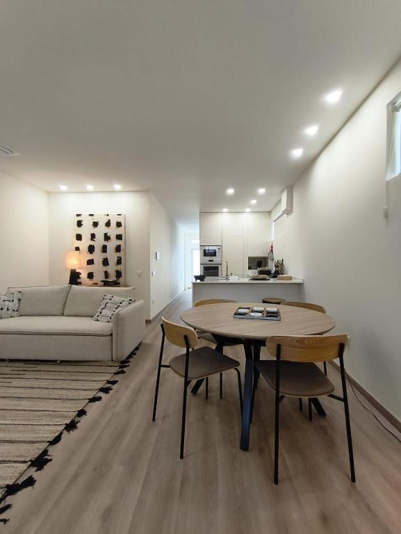 a living room with a table and chairs and a couch at Cidral Path 32 in Póvoa de Varzim