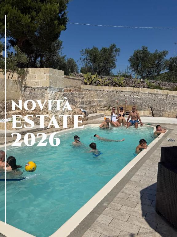 a group of people swimming in a swimming pool at Terra Bianca Salento in Nardò