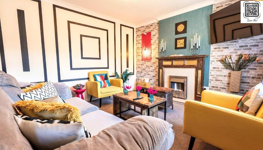 a living room with a couch and chairs and a fireplace at Unique By Monique Kingsholm Bungalow Parking in Gloucester