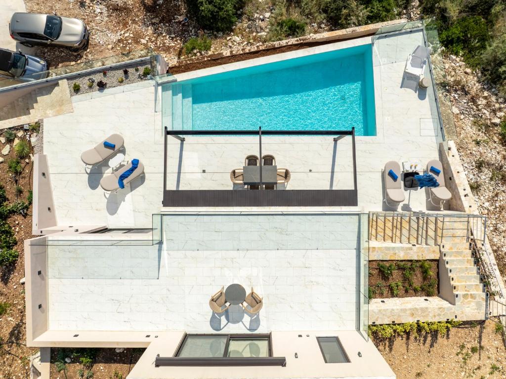 an overhead view of a house with a swimming pool at Meganisi Villas Royal in Meganisi