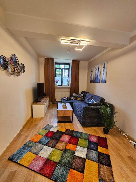 a living room with a couch and a rug at Ferienwohnung Stella in Zülpich