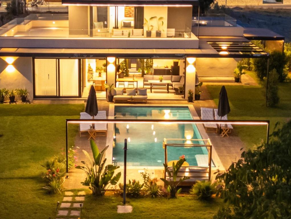 a house with a swimming pool in the backyard at Private Pool Villa by the Sea in Kalamata
