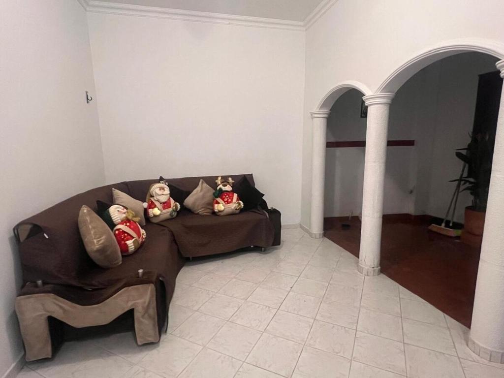 a living room with a couch with stuffed animals on it at Casa Vacacional San Gil Santander in San Gil