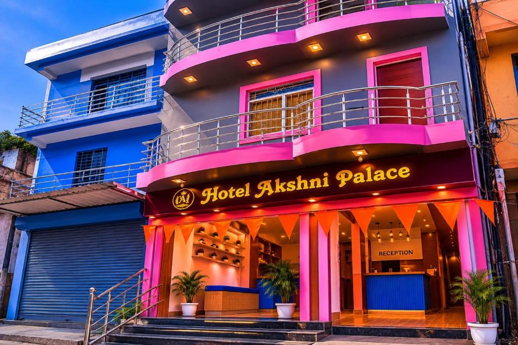 a building with a sign that reads food austin palace at Hotel Akshni Palace in Pūrnia