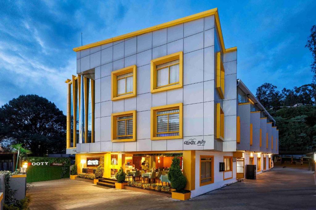 a building with a store in front of it at Meadows Residency in Ooty