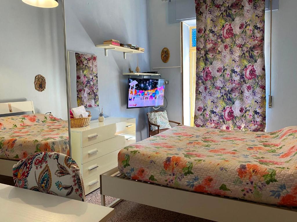 a bedroom with two beds and a mirror at Appartamento Nonna Ida in Montesarchio
