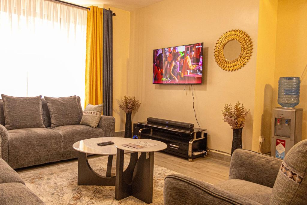 a living room with a couch and a table at PrimeCitySuites in Nakuru
