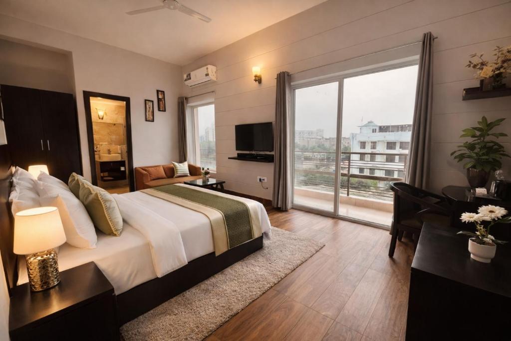a hotel room with a bed and a large window at Onyx Suite Luxury Apartment # Lift # Garden # Ac rooms # Private Parking # Near Prem Mandir # Located Inside- Omaxe Eternity Vrindavan # in Vrindāvan