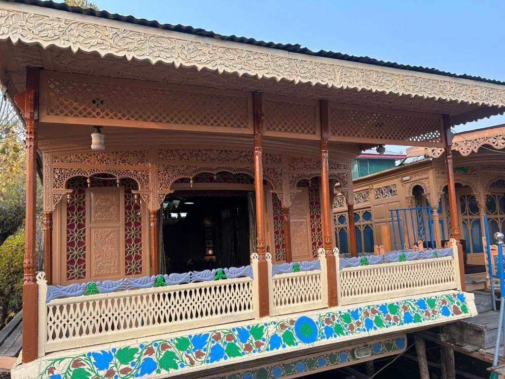 a large house with a balcony with mosaics on it at Luxury Egypt Group of House Boat in Srinagar