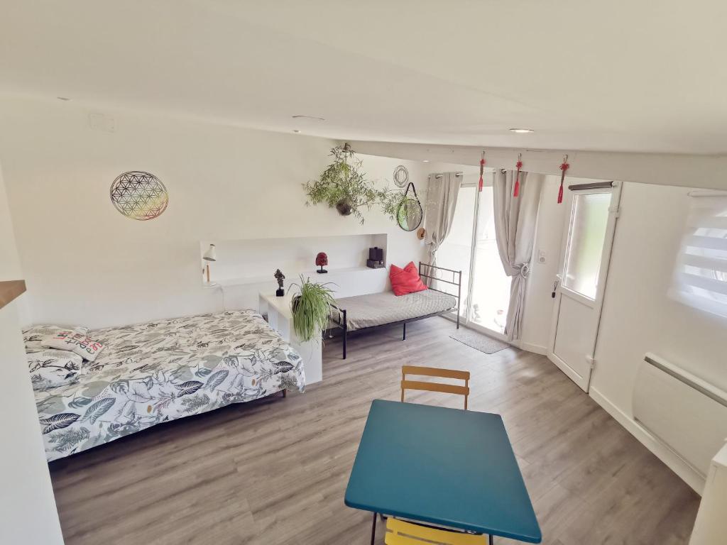 a bedroom with a bed and a blue table at Omnia in Saint-Maixent-lʼÉcole