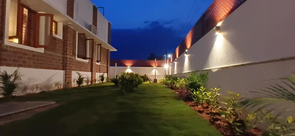 an alley between two buildings at night at Golden Loom Homestay in Kanchipuram