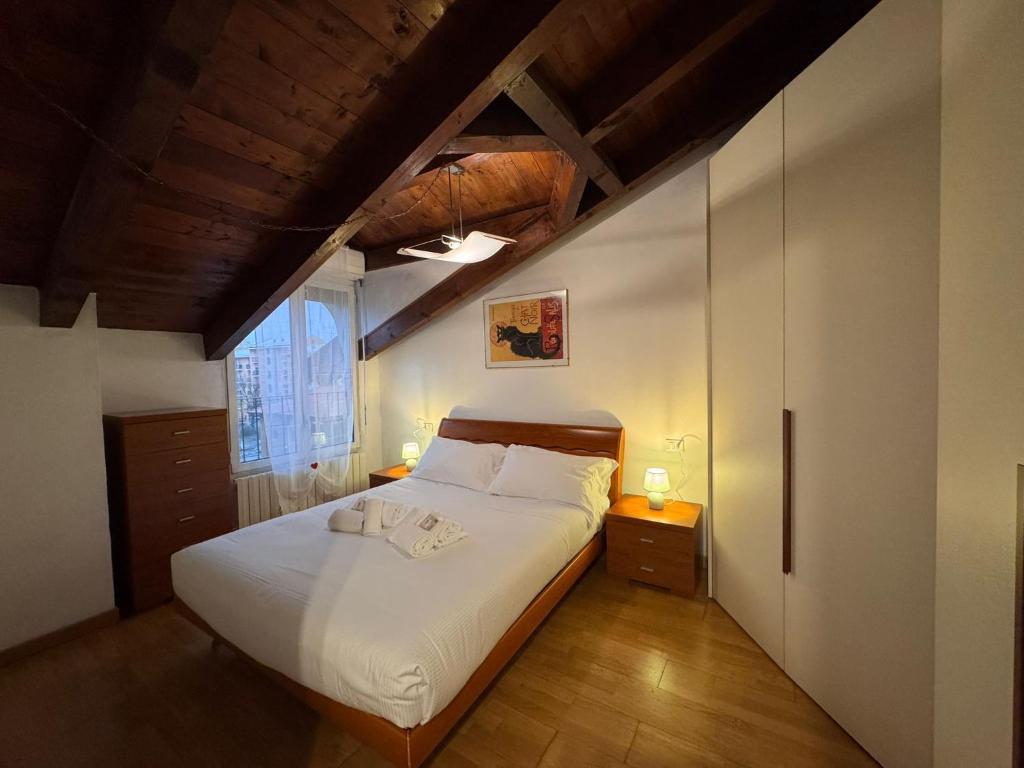 a bedroom with a large white bed in a room at L'Archè - The Rustic Loft in Cinisello Balsamo