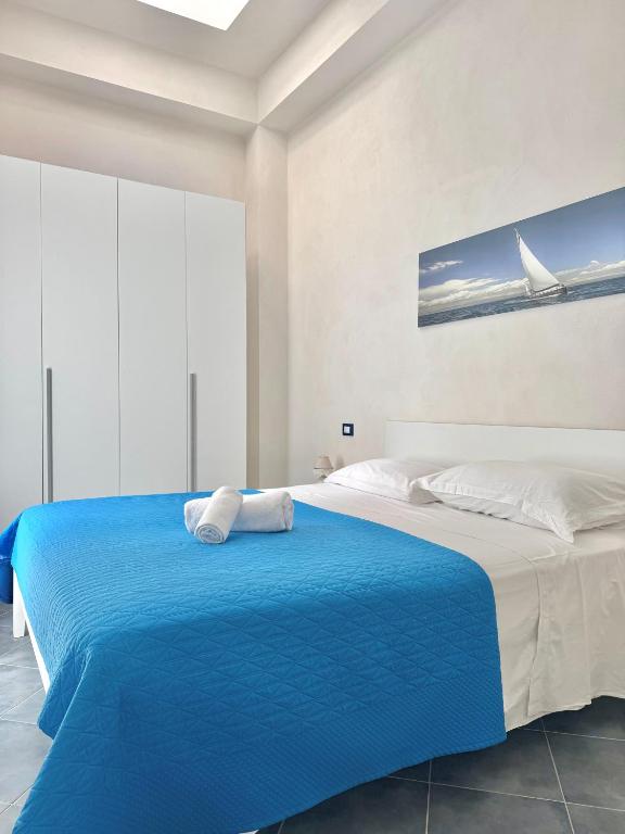 a bedroom with a blue bed with white sheets at L'angolo blu in Marettimo