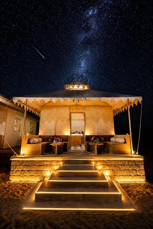 a building with stairs and lights at night at Desert Popular Resort & Camp in Jaisalmer