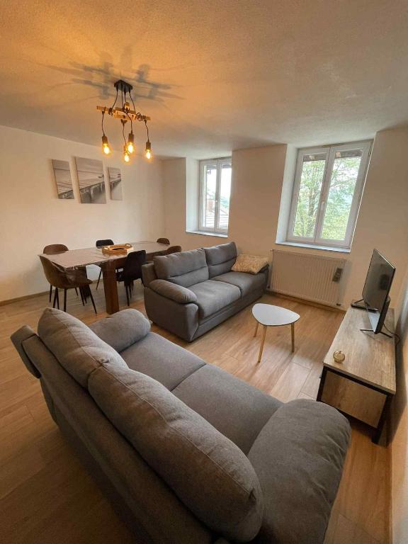 a living room with a couch and a table at Appartement à Vouglans in Lect