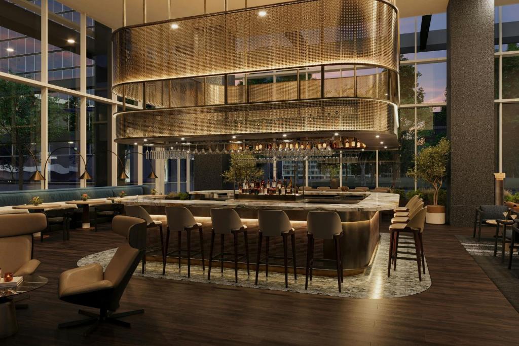 a restaurant with a bar in a building at JW Marriott Atlanta Downtown in Atlanta