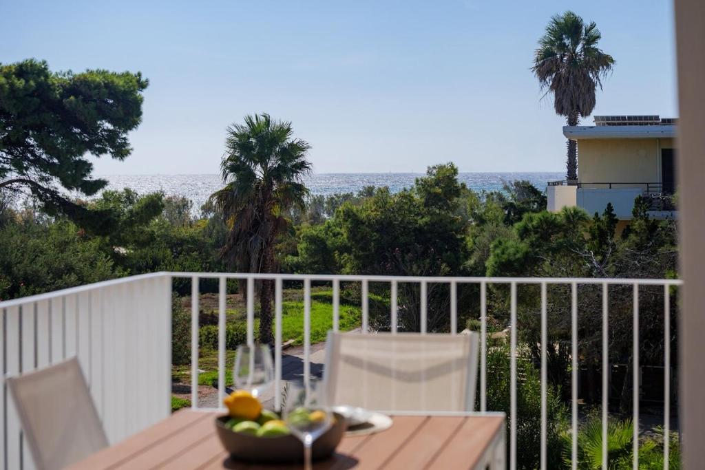 a table with a bowl of fruit on a balcony at PJ Properties Riviera Escape Suite Sounio in Sounio