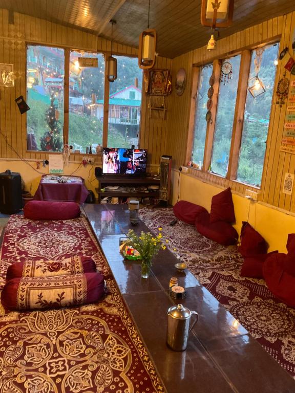 a living room with a couch and a table with pillows at The Soul Himalaya in Tosh