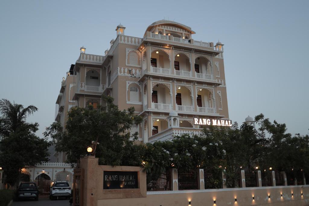 a large white building with a sign on it at Rangmahal Pushkar by DIV HOSPITALITY in Pushkar