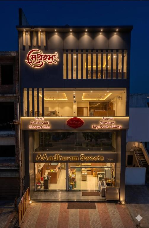 a store front of a building at night at Hotel Madhuram Shivpuri MP in Shivpurī