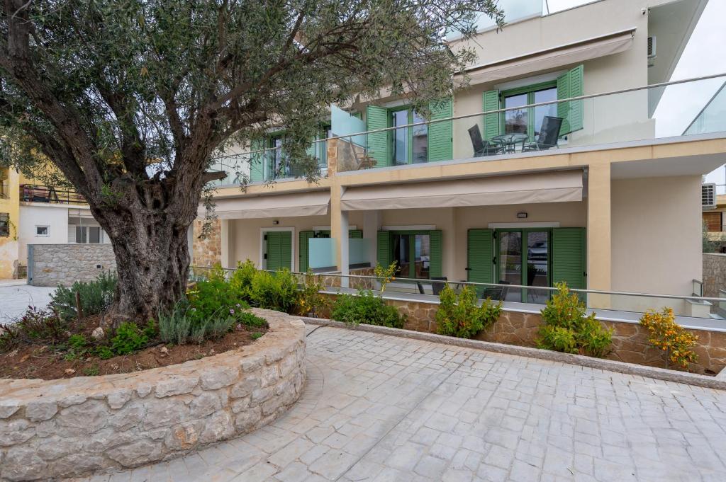 a tree in front of a building at Asini deluxe suite 5, with rooftop terrace and breathtaking views in Asíni