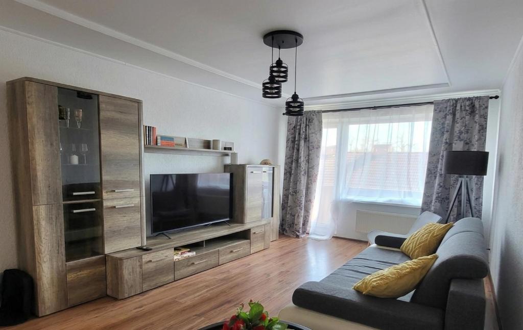 a living room with a couch and a flat screen tv at Apartment Omāri in Kolka